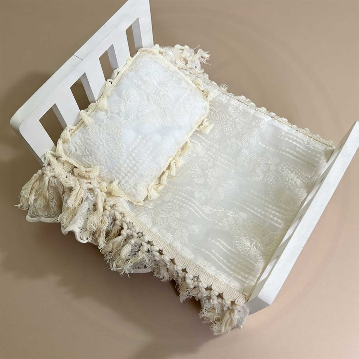 A 2-piece set featuring a newborn blanket and pillow with beige floral embroidery, and tassel trim for newborn photography props.