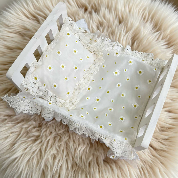 A 2-piece set featuring a chiffon daisy print pillow and blanket with lace trim, for newborn photography props.