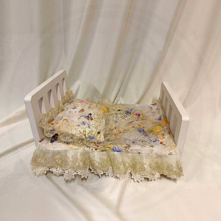 A 2-piece set featuring a newborn blanket and pillow with yellow floral butterfly print lace trim for newborn photography.