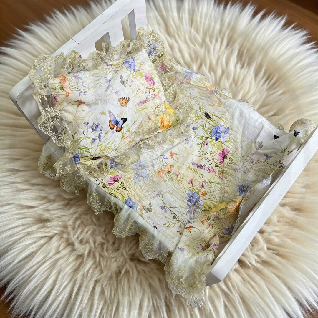 A 2-piece set featuring a newborn blanket and pillow with yellow floral butterfly print lace trim for newborn photography.