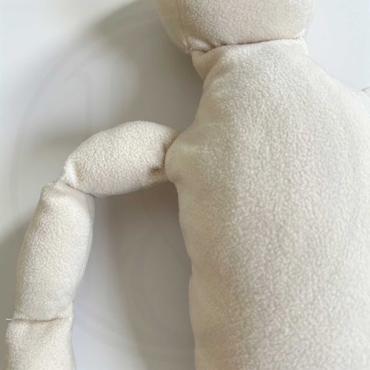 A close-up view of the doll's shoulder.