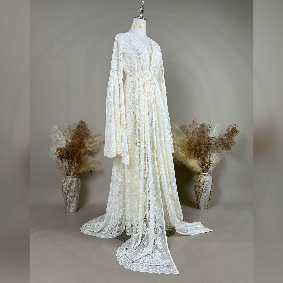 A beige lace ,Abrota dress with long bell sleeves and a V-neckline, displayed on a mannequin. 
