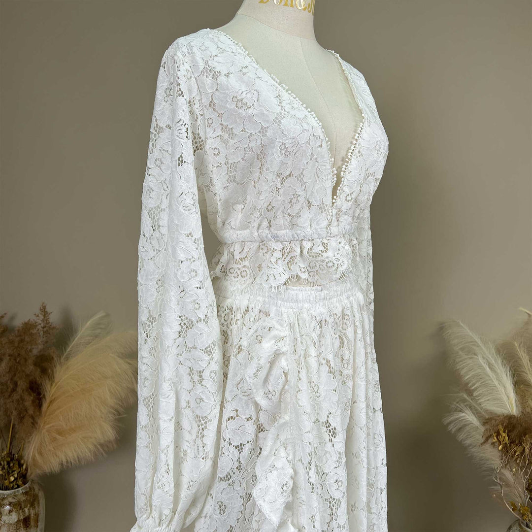 it's showing the V-neckline, long sleeves, and the construction of the elastic waistband joined with lace.