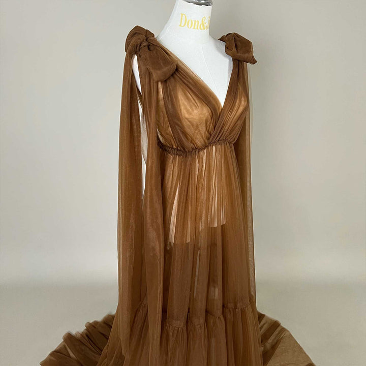 Close up of upper bodice details of the Acaste gown, showing the V-neckline, shoulder bow knots, and elastic waistband construction.