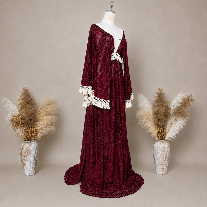 A Red wine,A bacche dress with a velvet cape and a white lace inner layer is displayed on a mannequin.