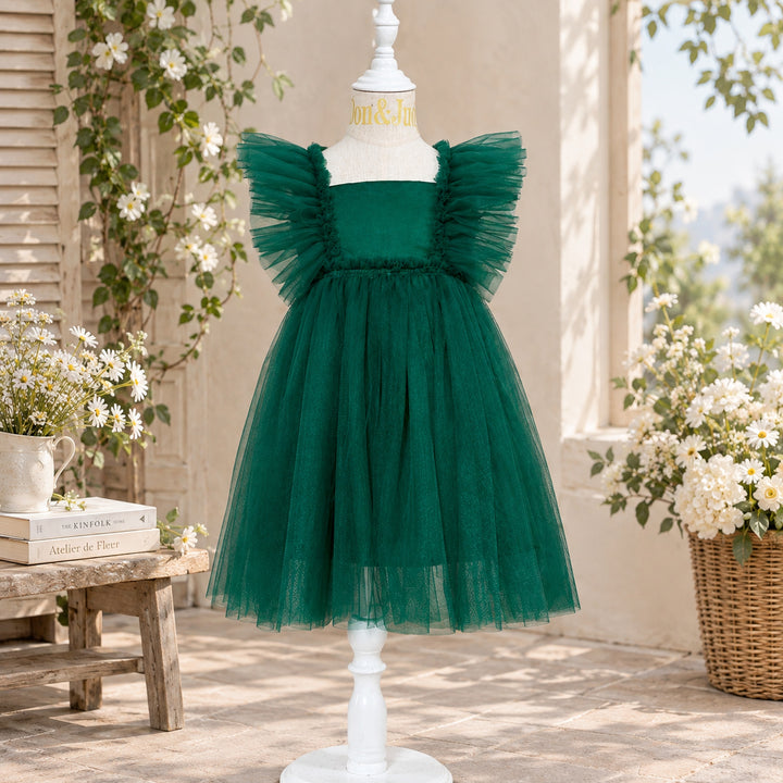 A Callisto green tulle dress on a mannequin with tulle ruffled shoulders