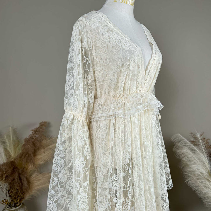 A close-up of the Clito beige lace dress bodice, showing the V neckline, waist ruffle and sleeve with a tie.