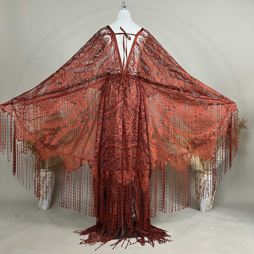 A mannequin displays a terracotta lace fringe robe with arms spread; the robe features a deep V-neck and wide sleeves