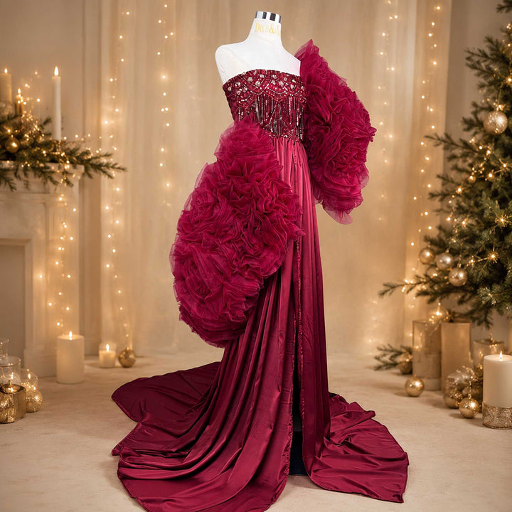 A red Luna one-shoulder evening gown is displayed on a mannequin with beaded details on the bodice.