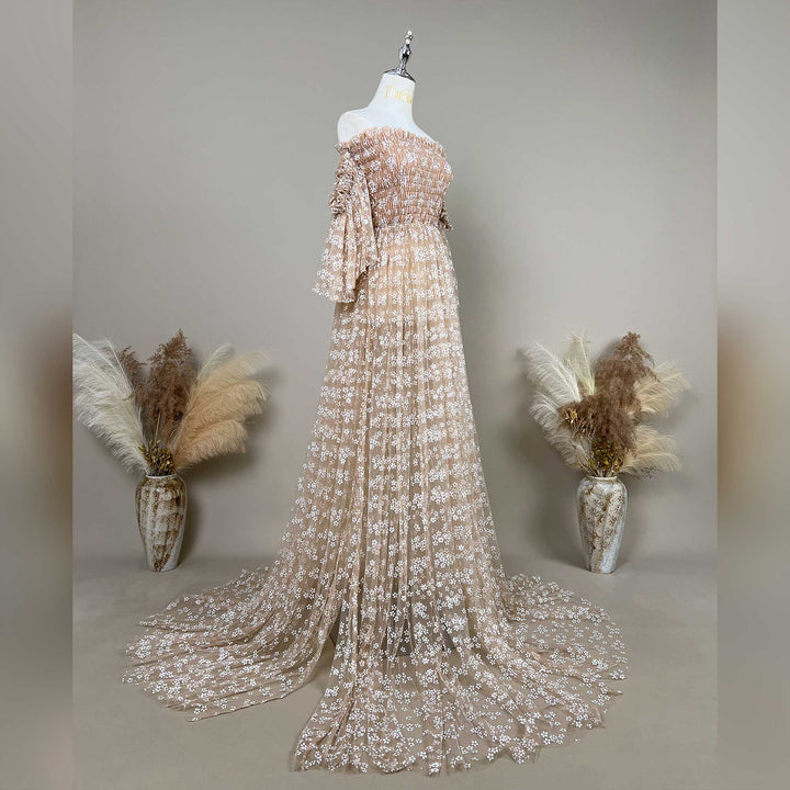 Alysianassa dress with floral embroidered off shoulder tulle details is displayed on a mannequin against a neutral gray background