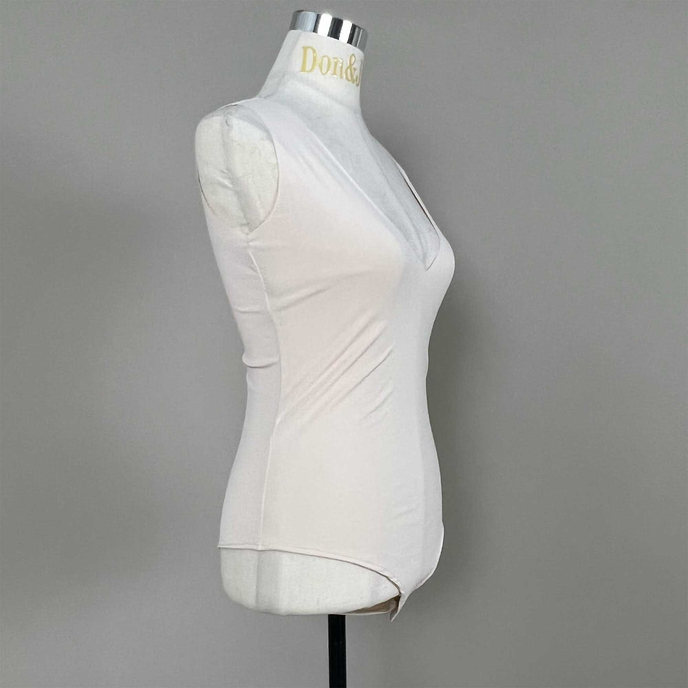 A mannequin shows a side view of a skin sleeveless bodysuit, revealing the V-neck silhouette and fitted cut; the hem features a curved high-cut design