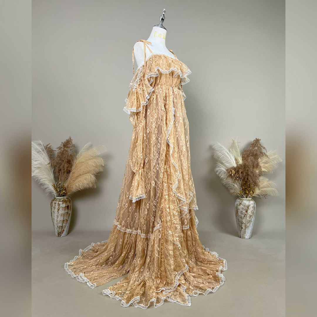 A Melinoe khaki lace maternity gown with cascading ruffles and a sweeping train is displayed on a mannequin.