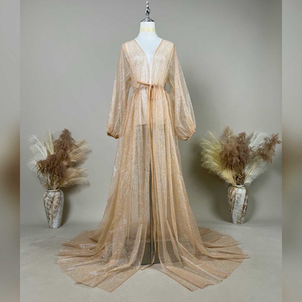 A mannequin displays a khaki sequined V-neck robe with a tie waist and lantern sleeves; the dress features a split train design, set against a solid wall with dried flower vases on both sides.