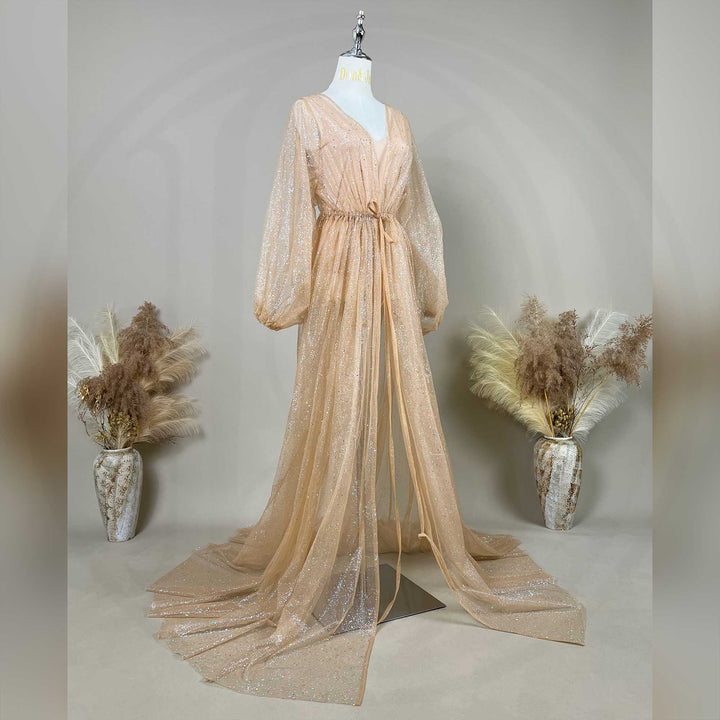 A mannequin displays a khaki sequined robe with a tie waist and lantern sleeves; the dress features a split train.