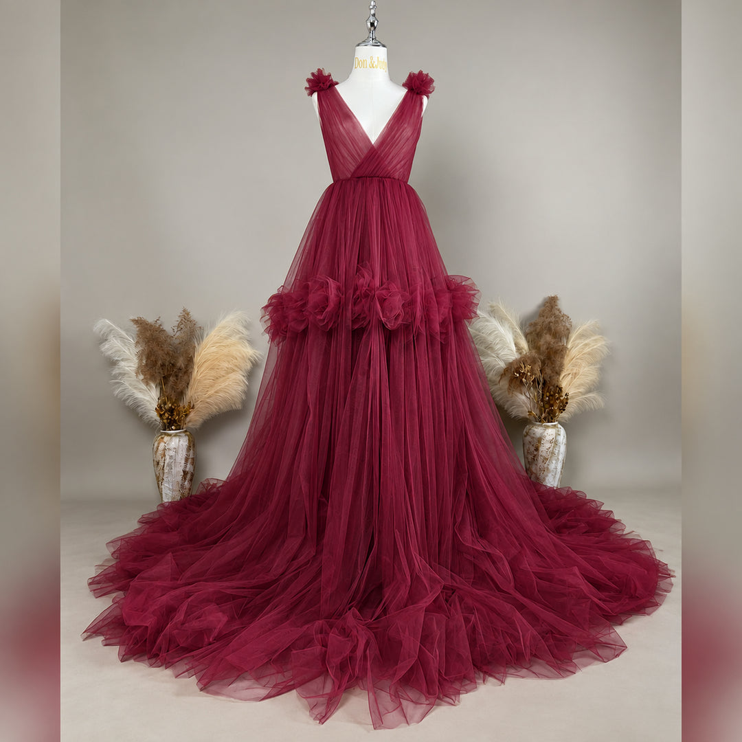 A Mila Color 108 tulle gown is displayed on a mannequin with floral details on the shoulders, waist, and neckline. 