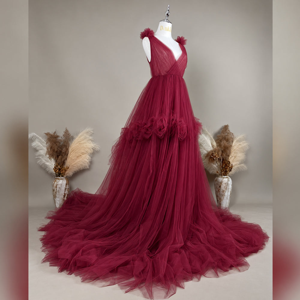 Side view of a  Mila Color 108 tulle gown is displayed on a mannequin with floral details on the shoulders, waist, and neckline. 