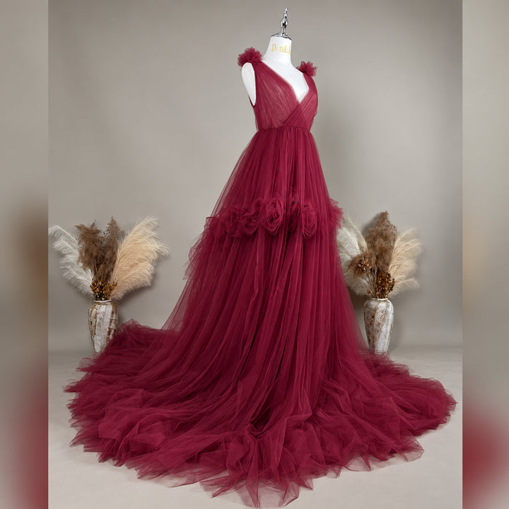 Side view of a  Mila Color 108 tulle gown is displayed on a mannequin with floral details on the shoulders, waist, and neckline. 
