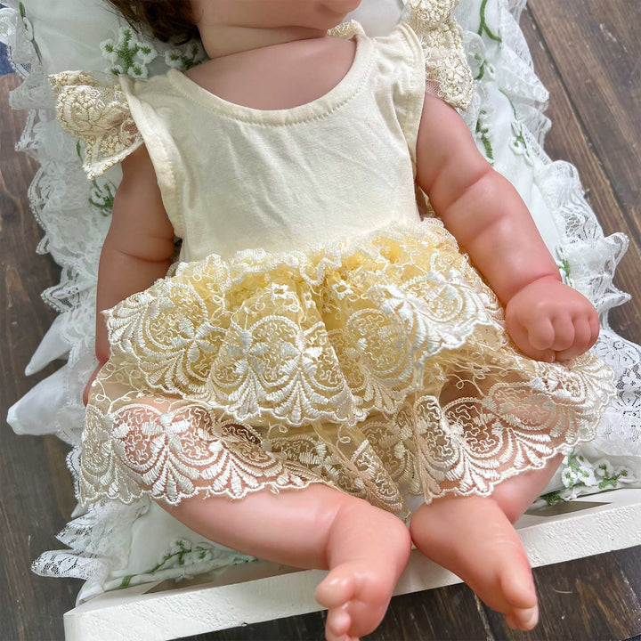 A close-up view of the Modal soft yellow double layer embroidered lace romper for newborn photography.