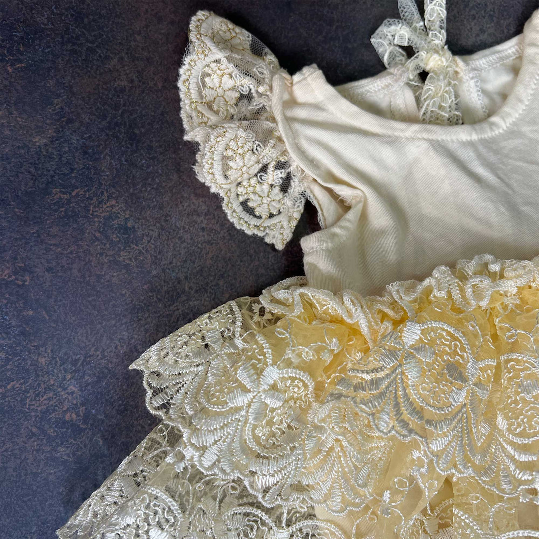 A close-up view of the Modal soft yellow double layer embroidered lace romper.