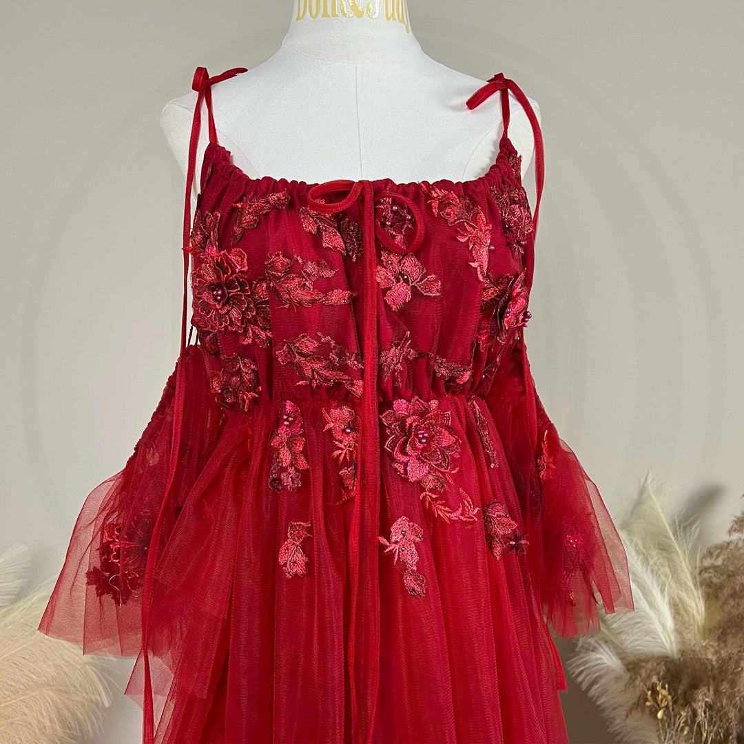 Close-up detail of the Red floral embroidered off-shoulder tiered ruffle maternity photography dress.
