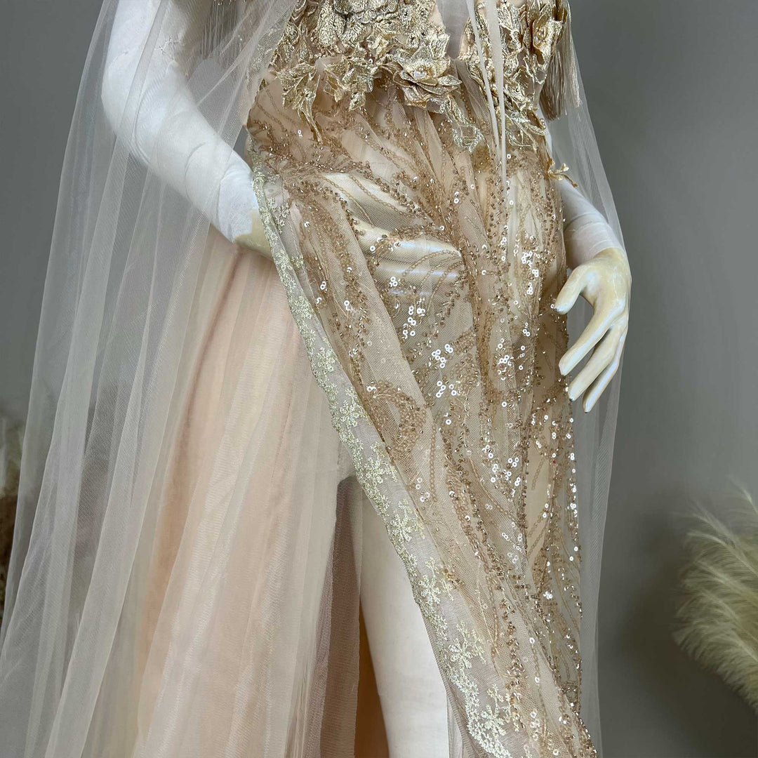 A mannequin displays the gown's skirt details, featuring gold sequined embroidered fabric and a side slit.