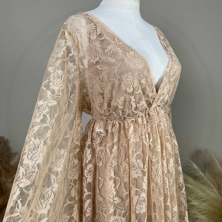 A khaki rose lace V-neck gown is displayed on a mannequin, featuring a ruched high waistline and wide bell sleeves