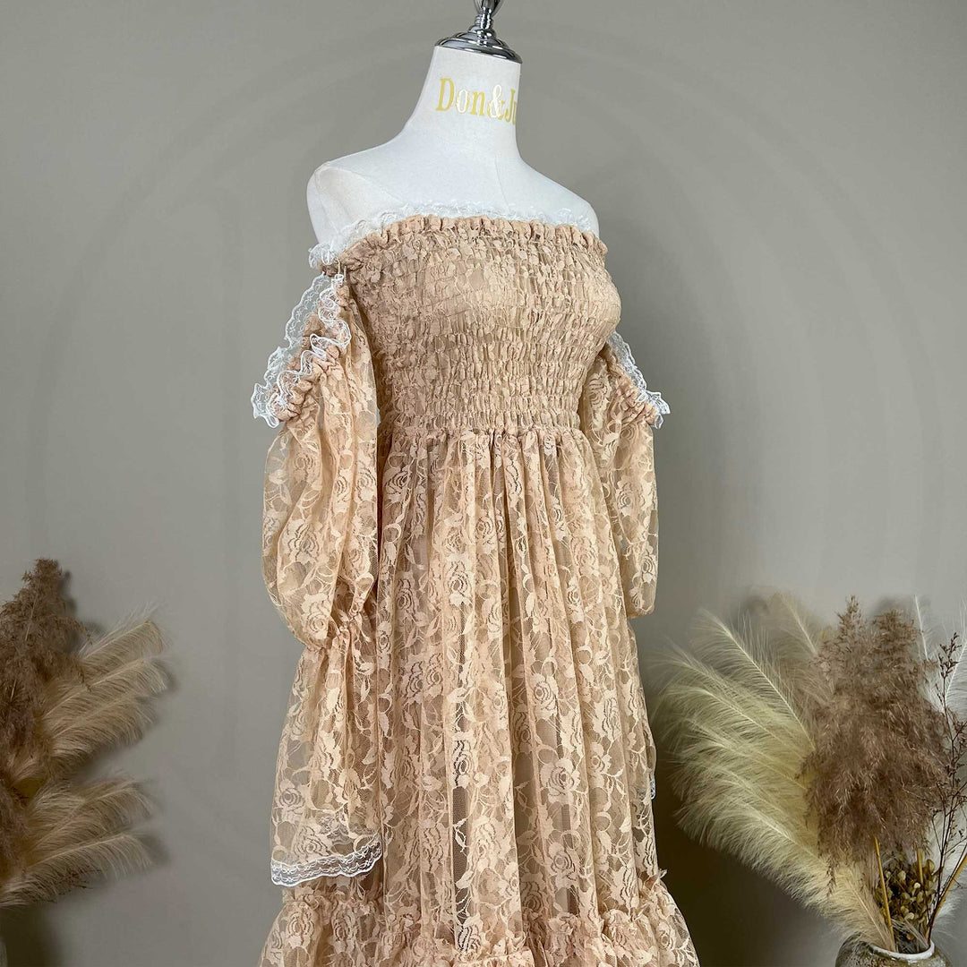 A khaki lace off-shoulder dress is displayed on a mannequin, featuring a shirred bodice, tiered ruffled sleeves, and rose patterns