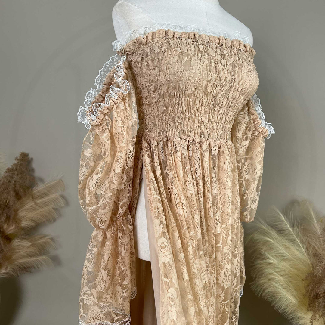 A khaki lace off-shoulder dress is displayed on a mannequin, featuring a shirred bodice, rose patterns, and white lace ruffled sleeves.