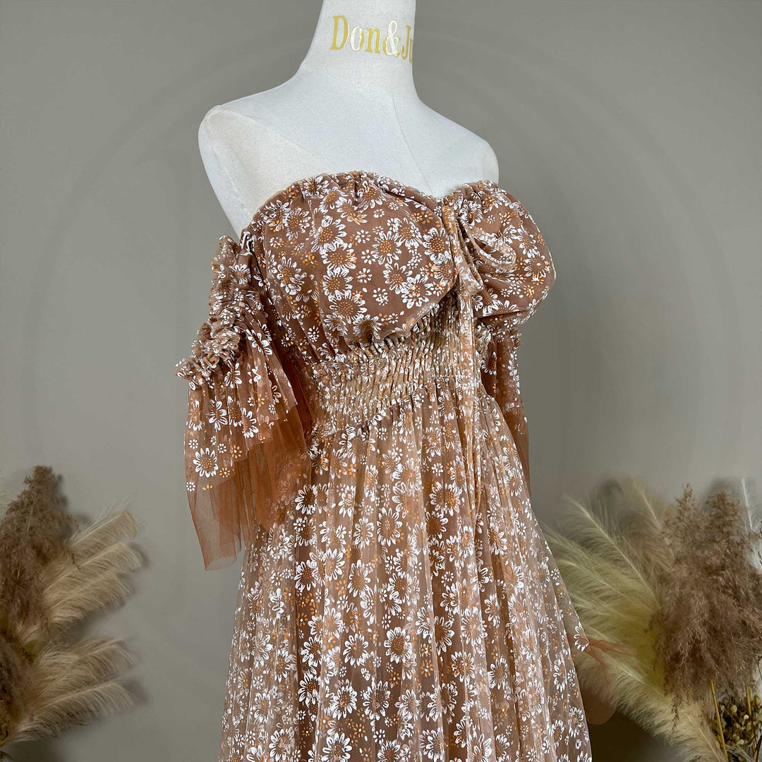 A Khaki Tyche dress is displayed on a mannequin with a front tie, elasticated waist.