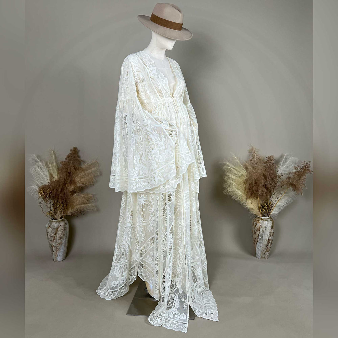 A beige lace ,Zephyra dress with long bell sleeves and a V-neckline, displayed on a mannequin. 