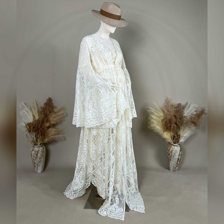 A beige lace ,Zephyra dress with long bell sleeves and a V-neckline, displayed on a mannequin. 